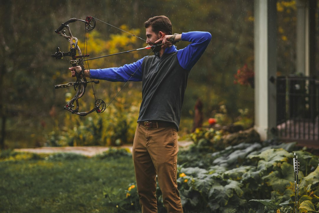Archer holding and aiming a bow at full draw