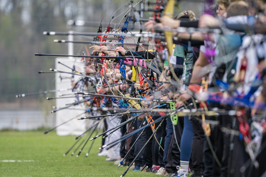Archers standing at a target range preparing to shoot