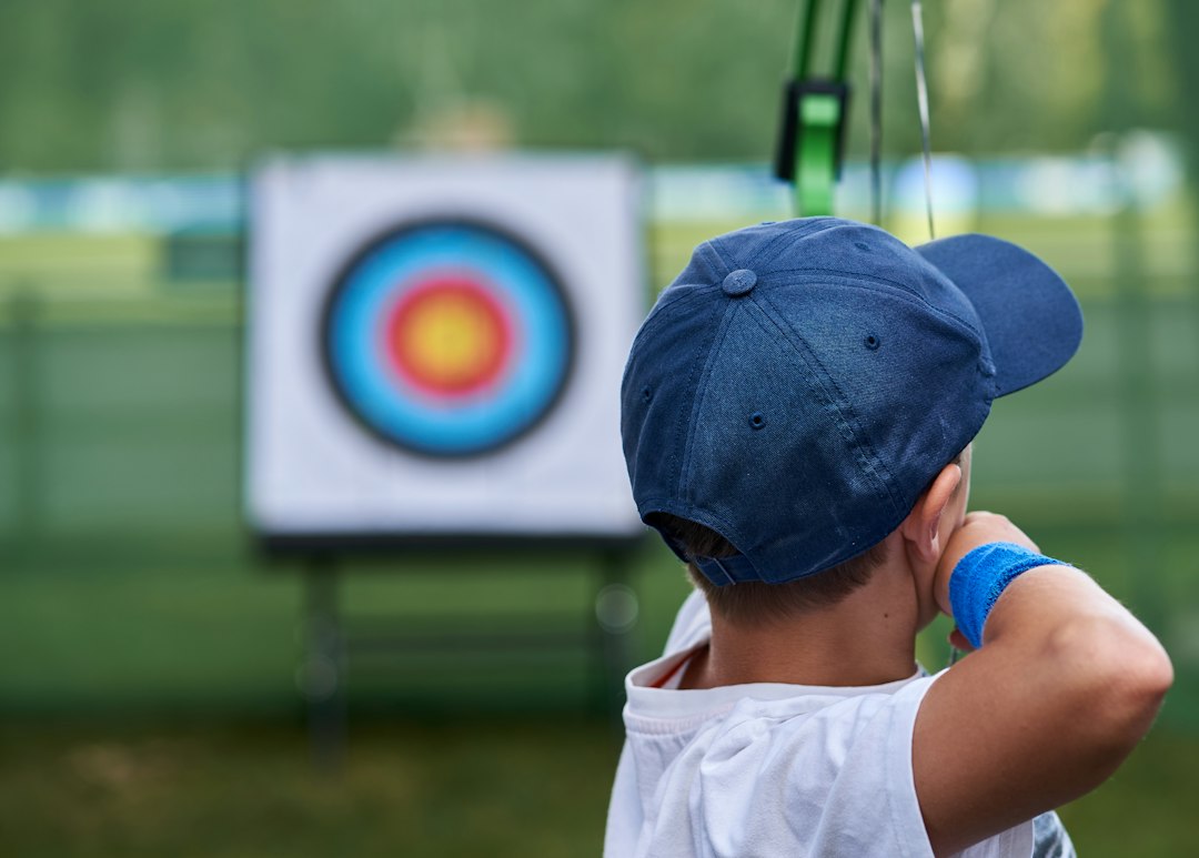 Beginner Archery Setup Cost: What to Budget Before You Buy 1 Young archer shooting an arrow at a target